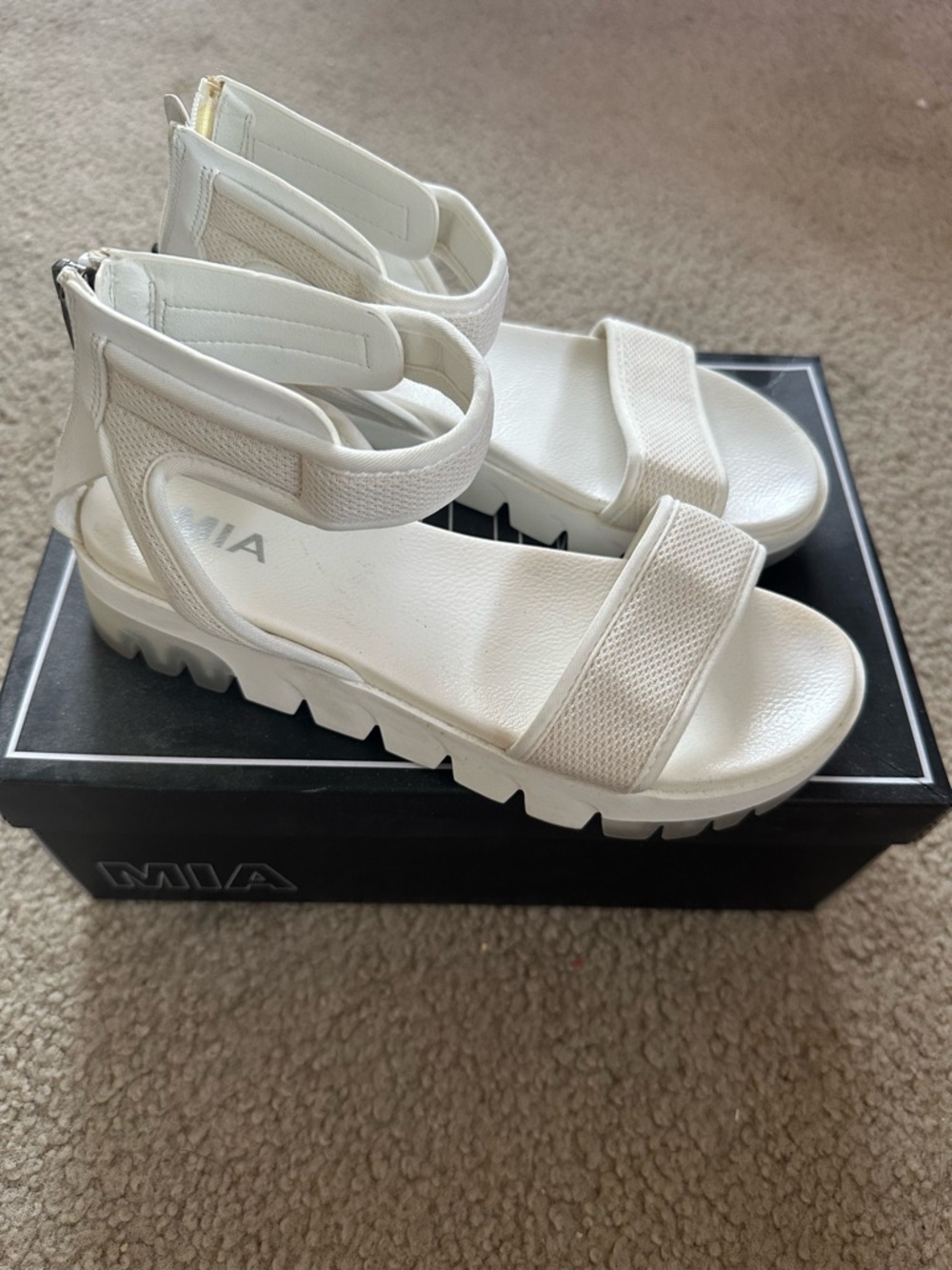 White sporty platform sandals with a chunky sole and breathable mesh straps